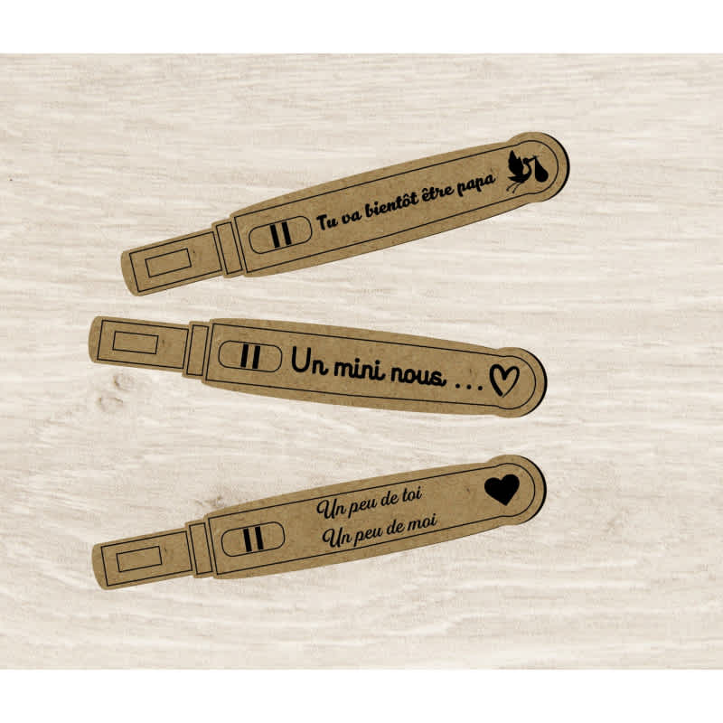 Wooden pregnancy test replicas with positive results and personalized French messages announcing pregnancy to the father and family